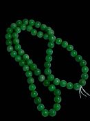 Green jade bead necklace, 76cm.