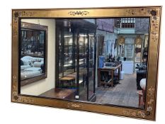 Black, gilt and floral decorated rectangular framed wall mirror, 102cm by 152cm.