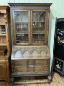 1920's/30's Lees style carved oak bureau bookcase having two glazed panel doors above a fall front