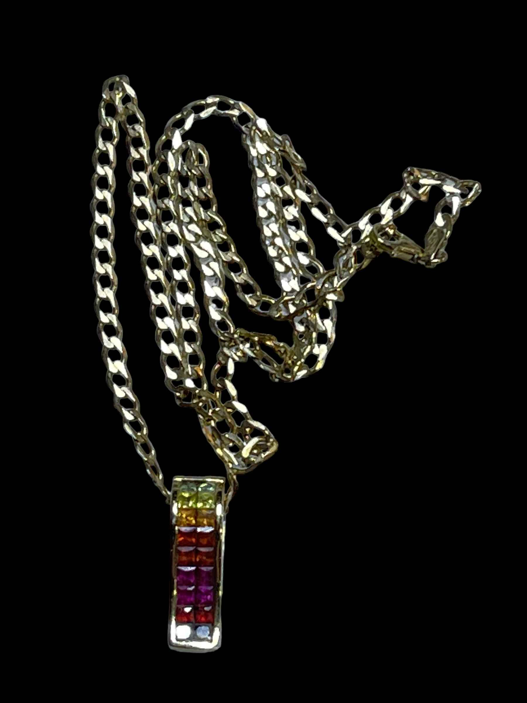 9 carat gold coloured sapphire set pendant and chain.