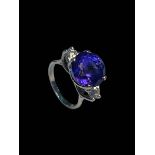 Impressive tanzanite and diamonds three stone ring set in 18 carat white gold,