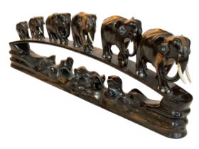 African hardwood carved bridge of elephants.