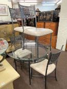 Contemporary circular glass topped and metal dining table and four chairs.