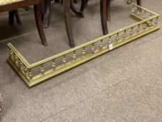 Brass fender with floral decorated spindles, internal measurements 129cm by 30cm.