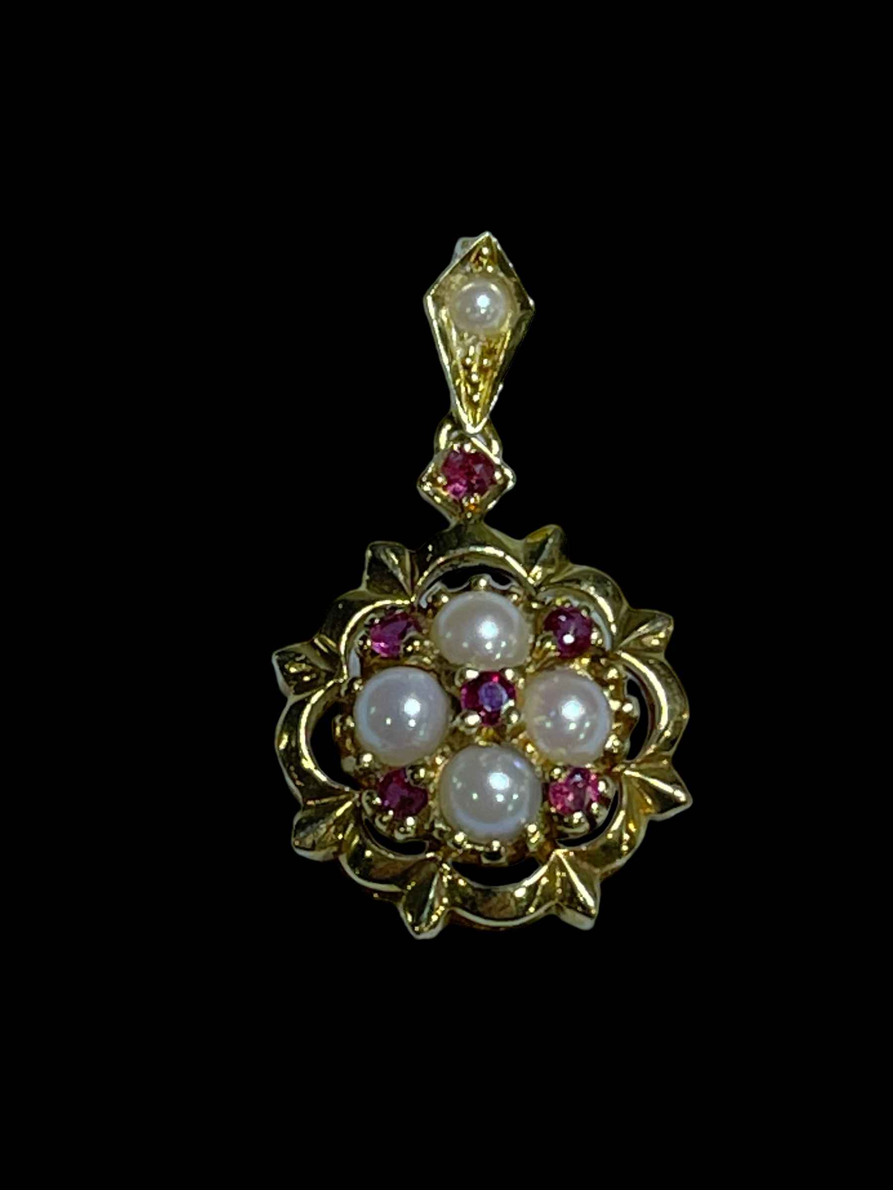 Pearl and ruby pendant set in 18 carat yellow gold.