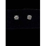 Pair of diamond stud earrings set in 18 carat white gold, diamonds approximately 0.60 carats.