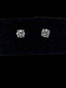 Pair of diamond stud earrings set in 18 carat white gold, diamonds approximately 0.60 carats.