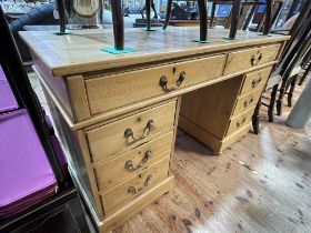 Waxed pine eight drawer pedestal desk, 79.5cm by 136.5cm by 64.5cm.