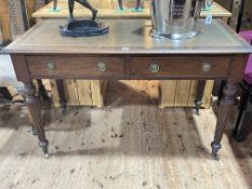 Victorian mahogany two drawer writing table on turned reeded tapering legs, 76.5cm by 124cm by 62.