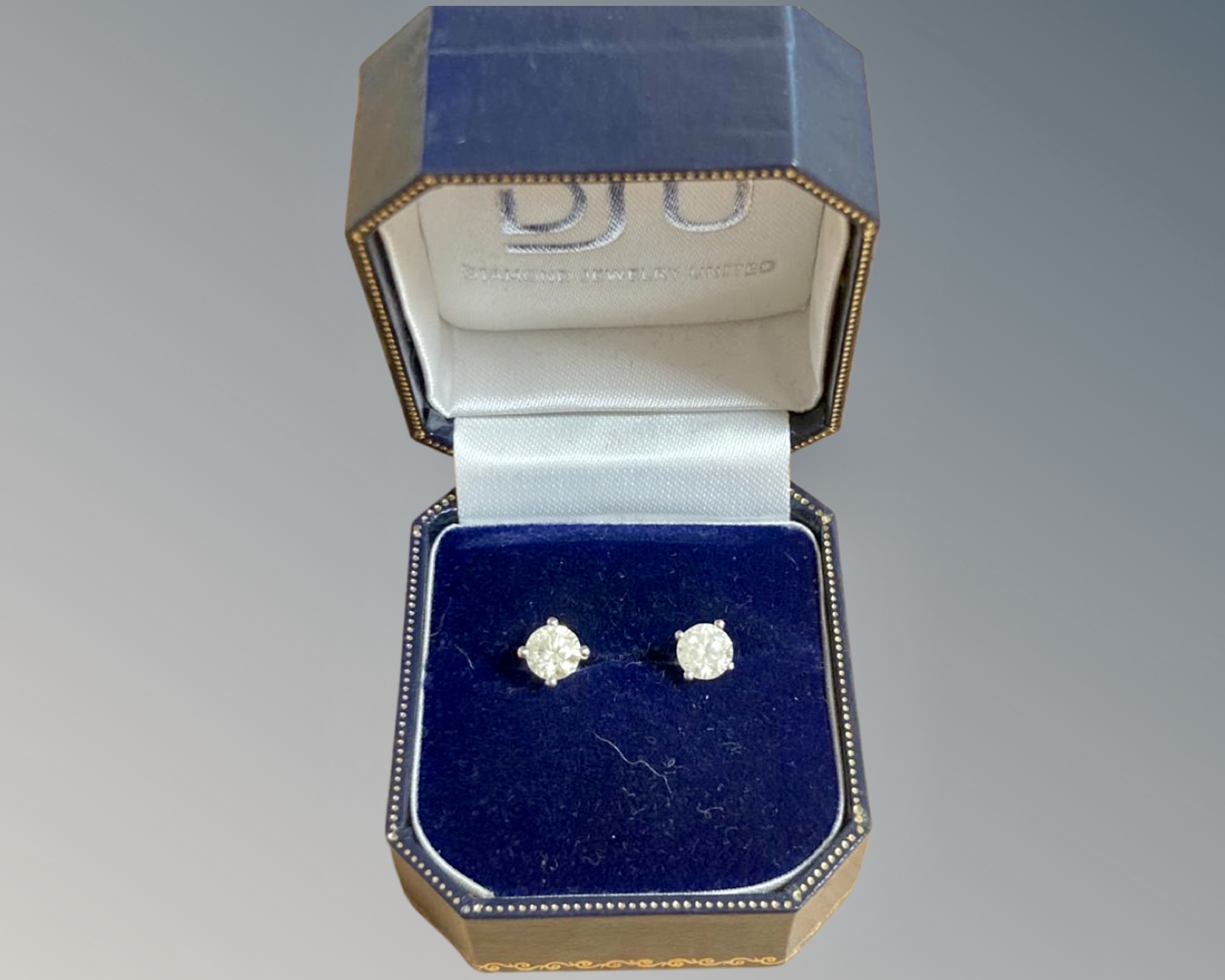 A pair of diamond stud earrings, the brilliant cut stones total 1. - Image 2 of 2
