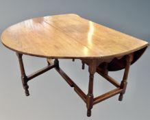A 19th century gateleg table with peg top and fitted drawer (length 138cm)