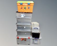 A collection of 10 assorted plastic storage boxes with lids.