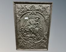 A cast iron panel depicting a knight on horseback.
