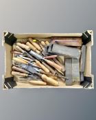 A box containing a quantity of vintage chisels, oil stones etc.