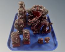 A tray containing nine Chinese resin figures.