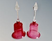 A pair of two tone glass hand bells.