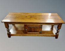 A Priory Oak two tier coffee table fitted with a cupboard (length 122cm)