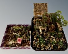 A box and a tray containing die cast metal Vietnam soldiers and dioramas.