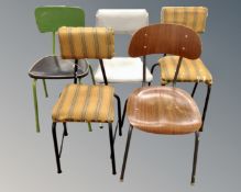 Five mid-20th century kitchen chairs on tubular metal legs.