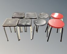 Eight assorted 20th century kitchen stools on metal legs.