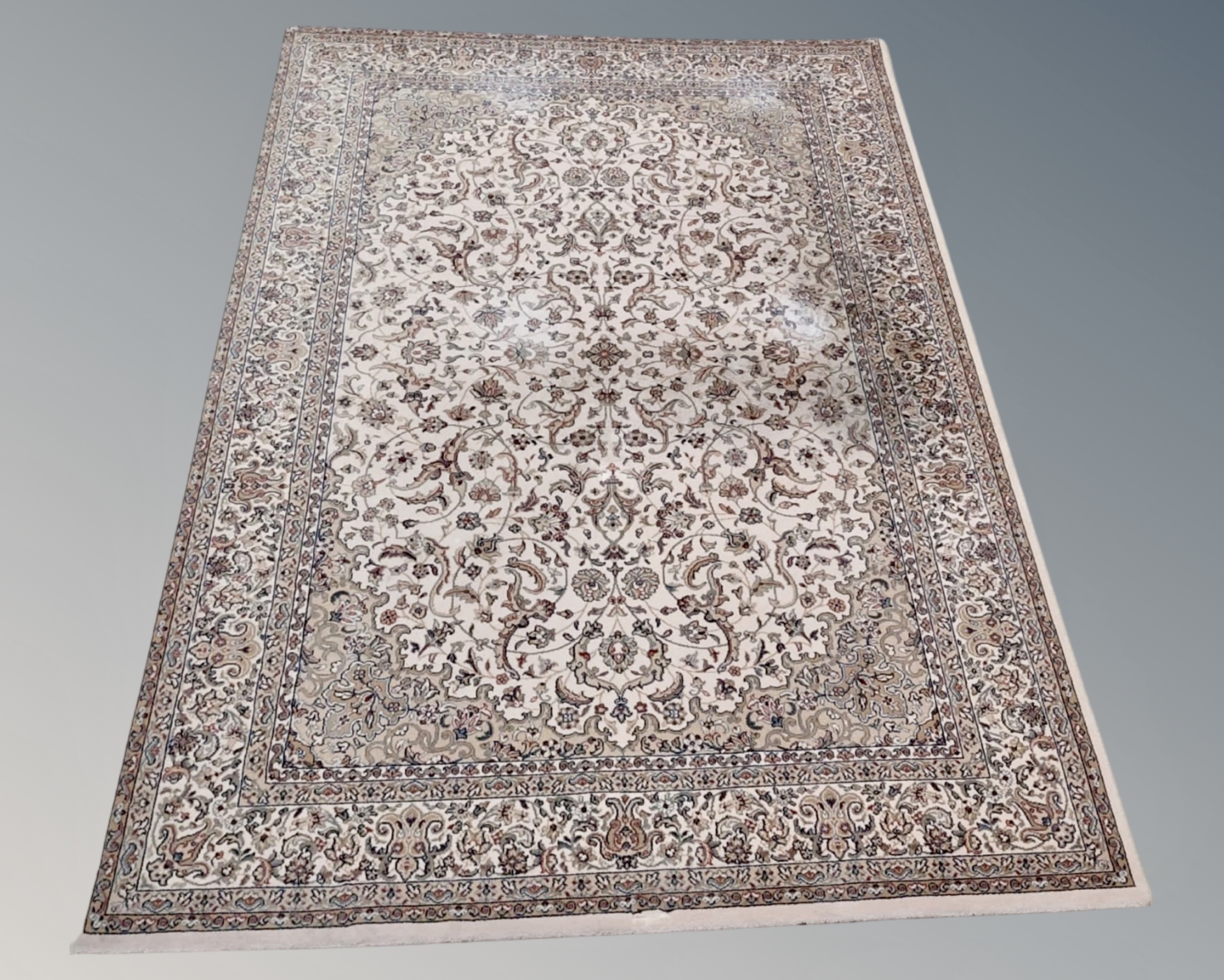 A machine made rug of Isfahan design, on cream ground,