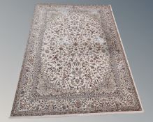 A machine made rug of Isfahan design, on cream ground,