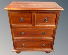 An Indonesian mahogany two-over-two four drawer chest.