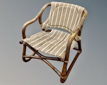 A late 20th century Scandinavian bamboo and wicker armchair upholstered in brown striped fabric.
