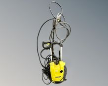 A Karcher K4 compact pressure washer with hoses.