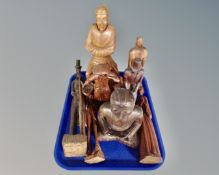 A tray containing eight carved wooden figures.