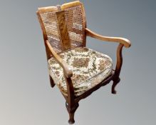 A 20th century beech wood bergere backed armchair.