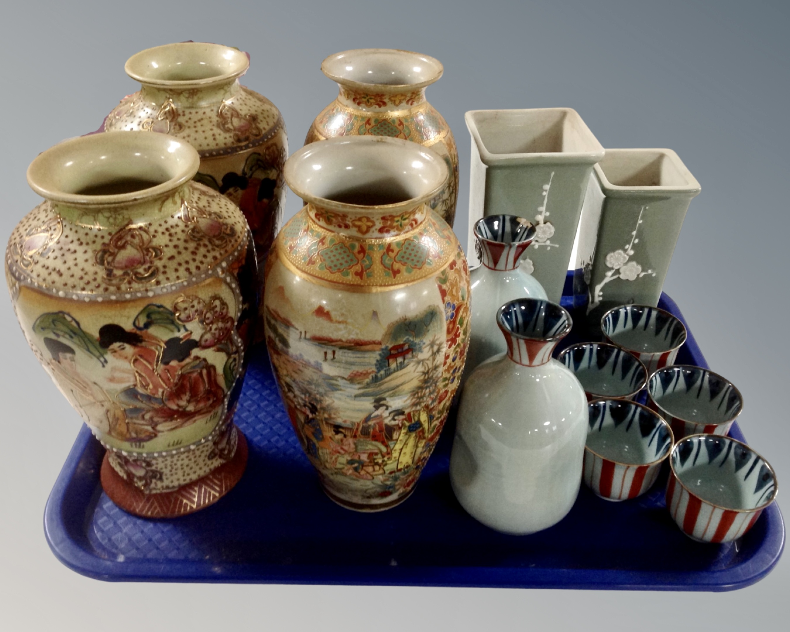 A tray containing Japanese vases and sake sets.