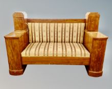 A 19th century inlaid mahogany Biedermeier settee upholstered in a striped fabric,