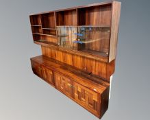 A mid century Danish rosewood twin section bookcase fitted with cupboards,