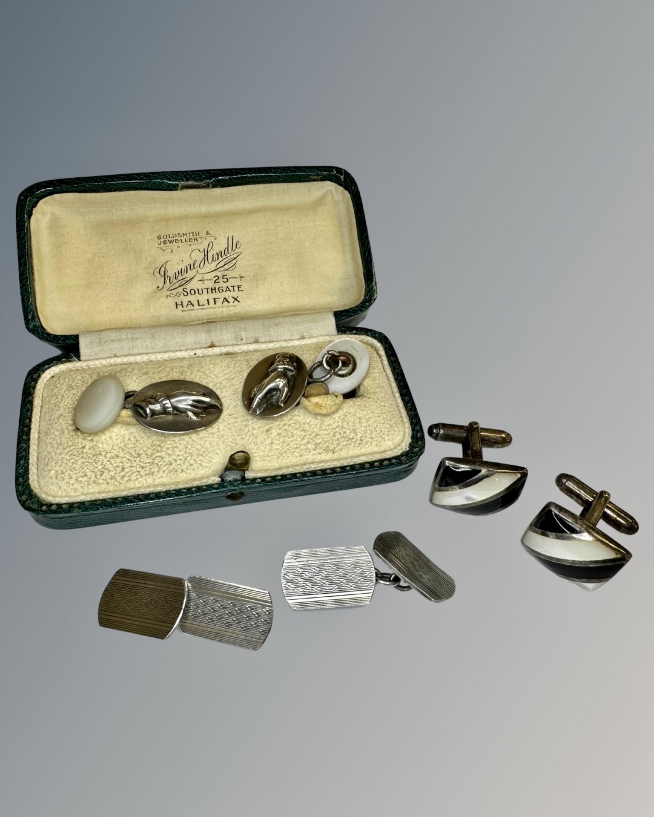 Three pairs of silver cufflinks.