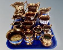 A tray containing 12 antique copper lustre jugs of various sizes,