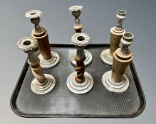 A tray containing six wooden and plated metal candlesticks.