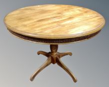 A contemporary circular pedestal kitchen table.