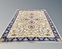 A fringed woolen Indian carpet of floral design, 340cm by 242cm.