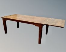 A contemporary hardwood refectory dining table with two leaves (length 218cm)