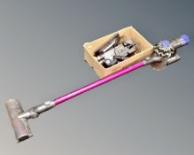 A Dyson V6 Absolute cordless vacuum with wall bracket, charger and accessories.