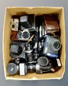 A box containing vintage cameras by Zenit, Pentax,