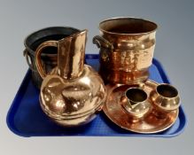 A tray containing assorted copper wares.