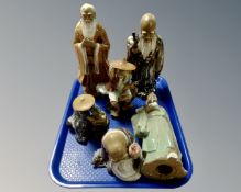 A tray containing six porcelain Chinese figures.