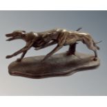 A contemporary bronzed resin figure of two greyhounds, length 29cm.