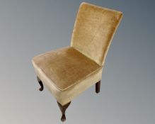 A mid-20th century bedroom chair upholstered in gold dralon.