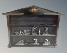 A Le Temps wooden curio stand together with nine assorted pewter figures.