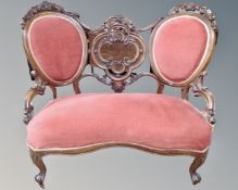 A 19th century mahogany framed salon window seat upholstered in pink dralon.