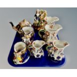 A tray containing a set of four Allertons Imari patterned jugs together with two Allertons lustre