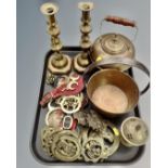 A tray containing antique and later brass ware including a pair of 19th century candlesticks,